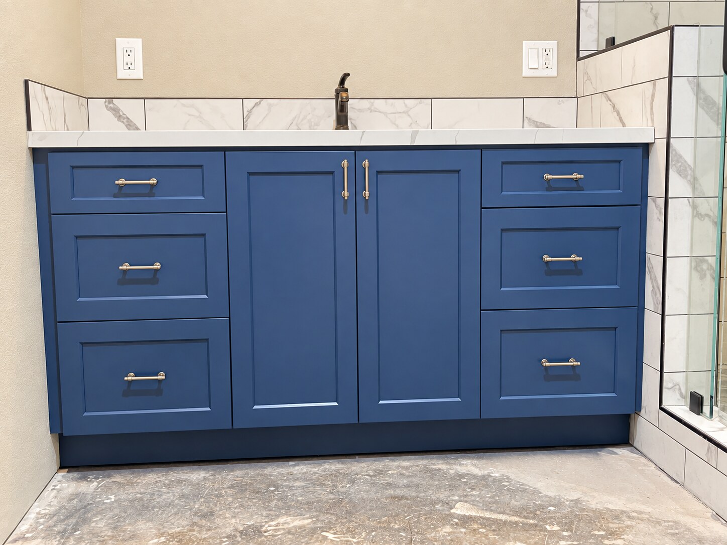 Blue bathroom vanity with a light countertop