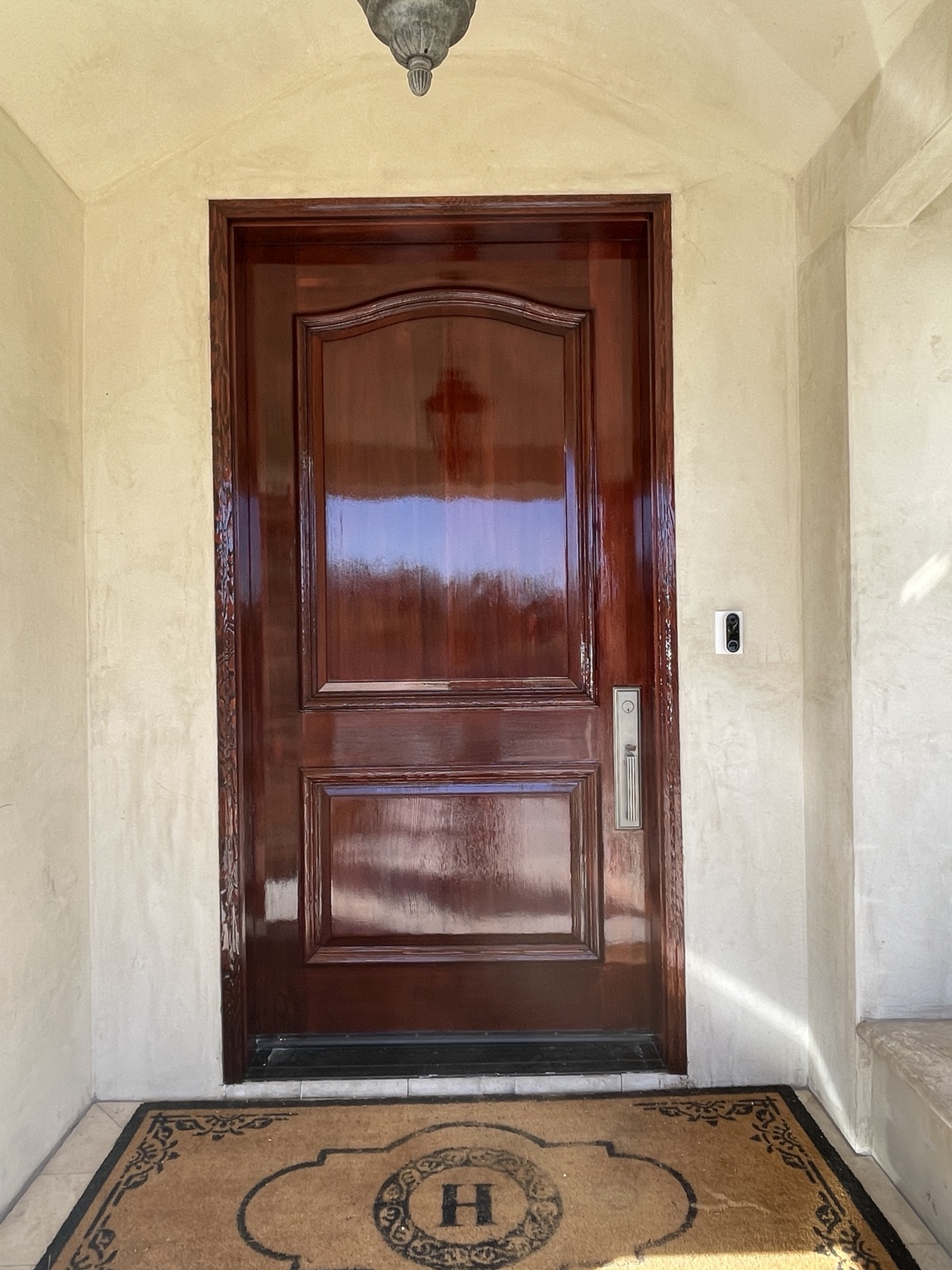 Wood entry door and matching casing with a rich reddish-brown gloss finish