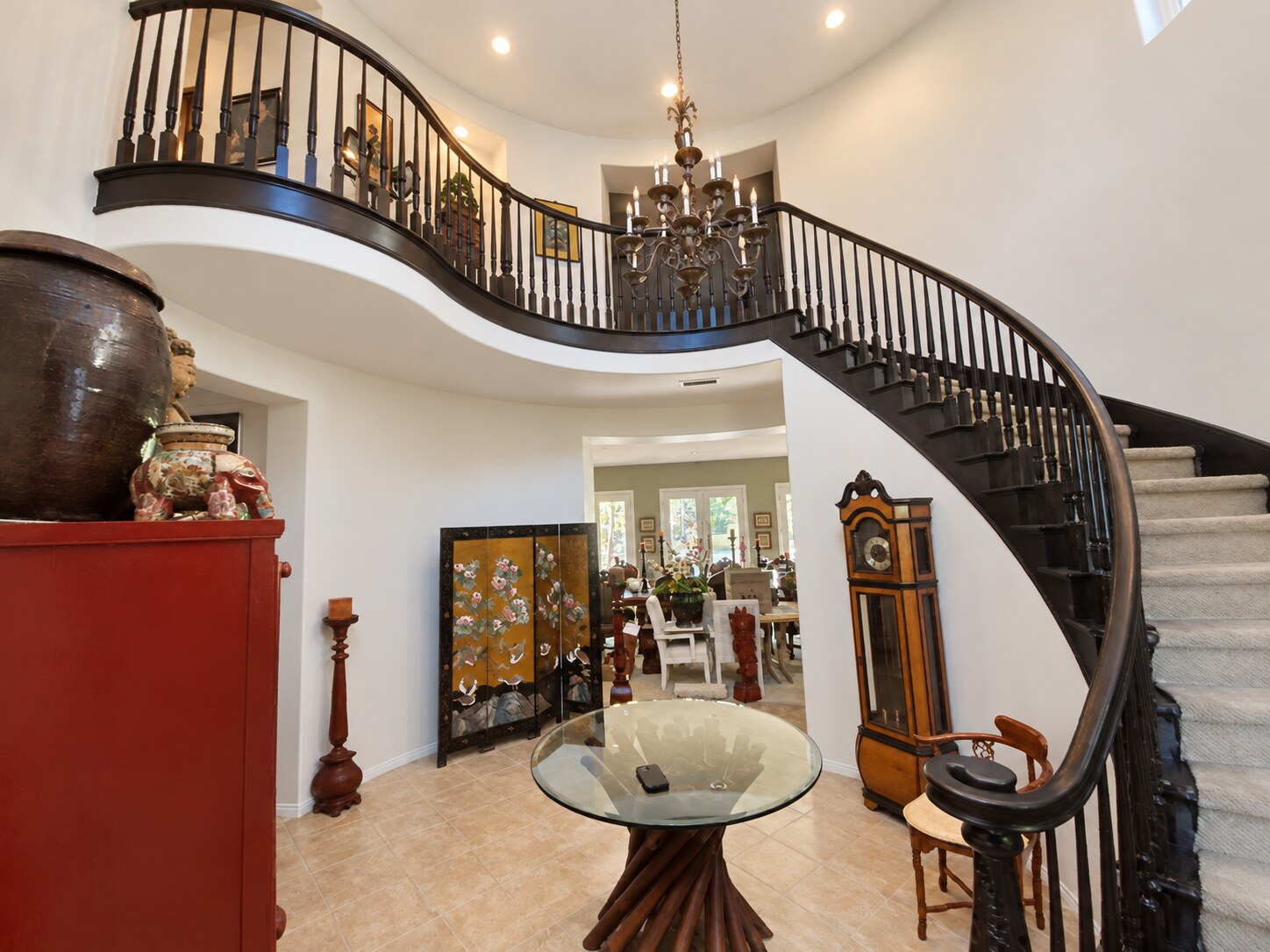 Curved staircase with a black satin handrail and balusters