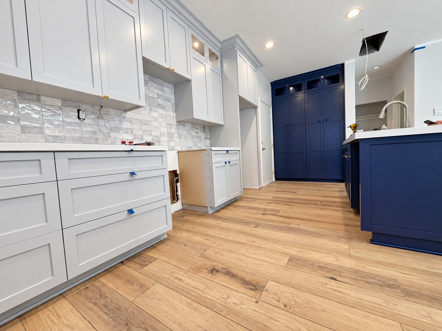 White perimeter cabinets with deep purple pantry cabinetry and kitchen island