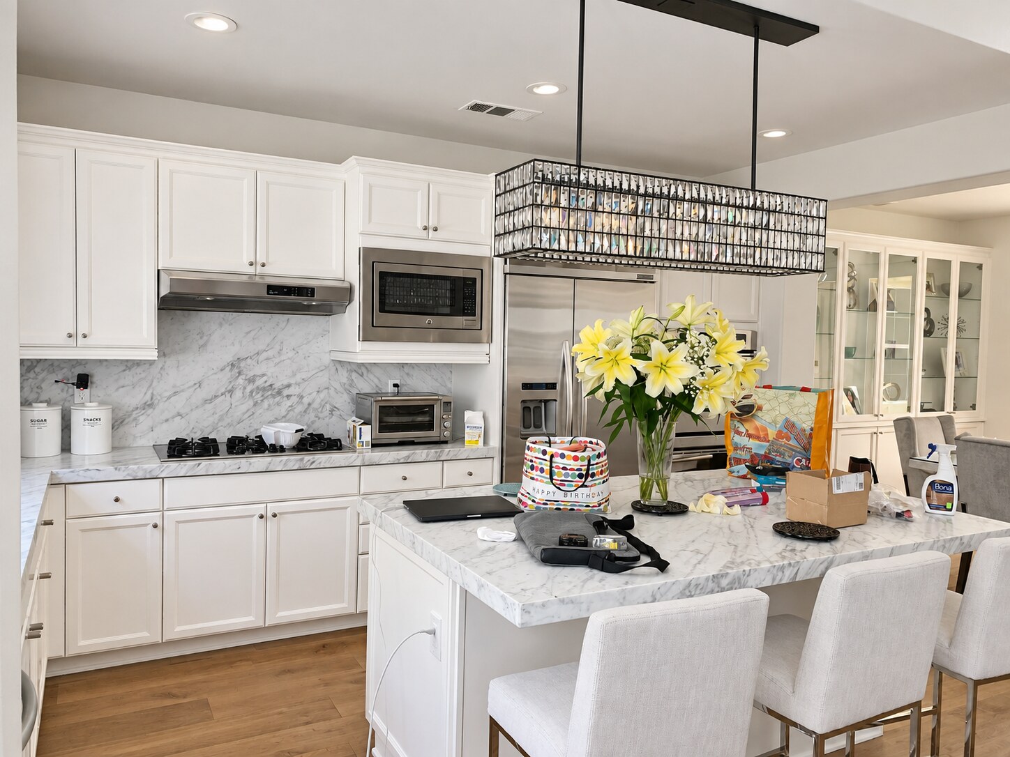 Crisp white kitchen cabinetry with a matching white island